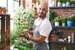 © Krakenimages.com - Young bald man florist using difusser working at florist