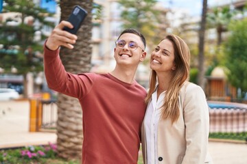 Sticker - Man and woman mother and son smiling confident make selfie by the smartphone at park