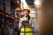 © Jirus - Asian female worker wearing Hard Hat Checks Stock and Inventory with clipboard in the Retail Warehouse.