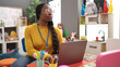 © Krakenimages.com - African woman preschool teacher using laptop at kindergarten