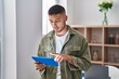 © Krakenimages.com - Young hispanic man using touchpad standing at home