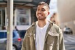 © Krakenimages.com - Young hispanic man smiling confident standing at street