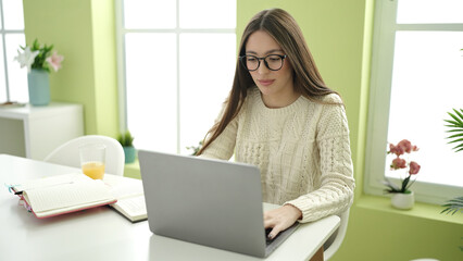 Sticker - Young beautiful hispanic woman student using laptop studying at home