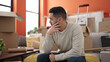 © Krakenimages.com - Young hispanic man sitting on sofa with relaxed expression at new home