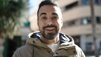 Sticker - Young hispanic man smiling confident standing at street