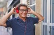 © Krakenimages.com - Middle age man smiling confident listening to music at street