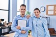 © Krakenimages.com - Man and woman business workers smiling confident holding checklist at office