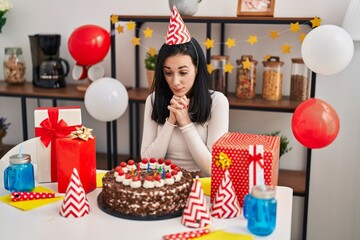 Wall Mural - Young caucasian woman celebrating birthday sitting on table at home