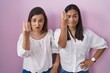 © Krakenimages.com - Hispanic mother and daughter together doing italian gesture with hand and fingers confident expression