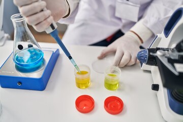 Poster - Young hispanic man scientist using pipette working at laboratory