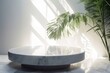 Empty modern glossy marble light-grey round podium table in tropical tree dappled sunlight, leaf shadow on white wall, background for beauty product