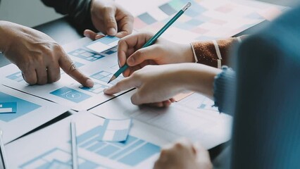 Close up ux developer and ui designer brainstorming about mobile app interface wireframe design on table with customer breif and color code at modern office.Creative digital development agency