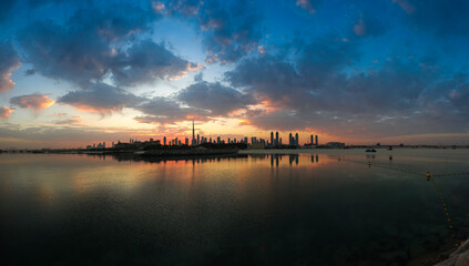 Wall Mural - Sunrise over Dubai skyline. Wide angle photo with amazing color sky clouds over Dubai skyscraper buildings. Travel to United Arab Emirates.