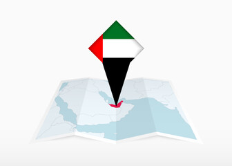 Wall Mural - United Arab Emirates is depicted on a folded paper map and pinned location marker with flag of United Arab Emirates.