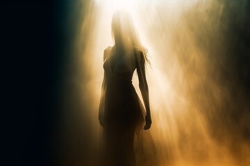 Abstract woman silhouetted against a bright ray of back lit sunshine.