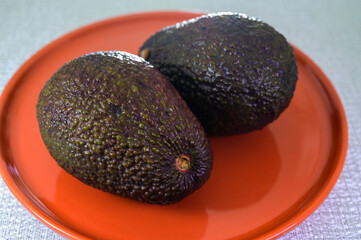 Two fresh ripe raw hass avocados, close up, healthy food concept