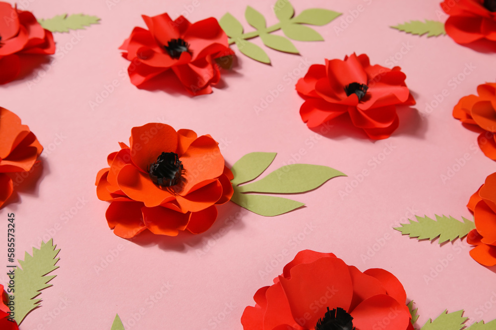 Paper poppy flowers with leaves on pink background