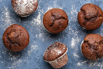 Tasty chocolate cupcakes on blue background