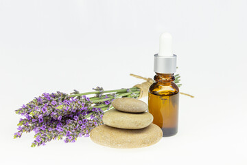 Wall Mural - Amber essential lavender oil bottle. Pipette with drop and bottle on an isolated background.