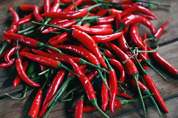 Wall Mural - Chili pepper, Red hot chilli peppers on wooden background. Close up group of ripe red chilli