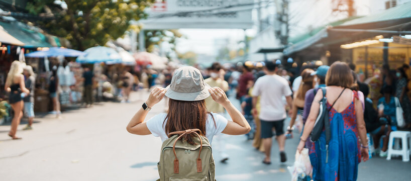 woman traveler visiting in bangkok, tourist with backpack and hat sightseeing in chatuchak weekend m