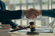 © ArLawKa - Agreement, Law, Advice and Justice Businessman shaking hands to sign agreement with lawyer, partner or his attorney on contract agreement. office law