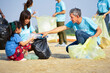 group of volunteers cleanup at the sand beach and adult help children collect and separate plastic bottle for recycle, concept of environmental conservation,  campaign, awareness, support