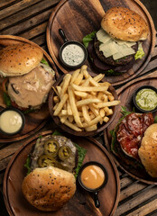 Wall Mural - many different gourmet burgers selection on wood table