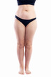 © Анна Демидова - Overweight woman with cellulite and varicose veins in black underwear. Full height. Obesity and disease. Isolated on white background. Vertical.
