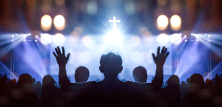 easter and good friday concept, soft focus of christian worship with raised hand on white cross back