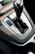 Modern car interior, black perforated leather, aluminum, details controls.