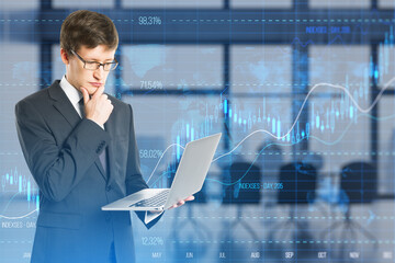 Sticker - Attractive thoughtful european businessman using laptop with glowing candlestick forex chart with index on blurry office interior background. Trade, stock and finance concept. Double exposure.