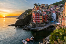 Italy, Liguria, Riomaggiore, Edge of coastal village along Cinque Terre at sunset