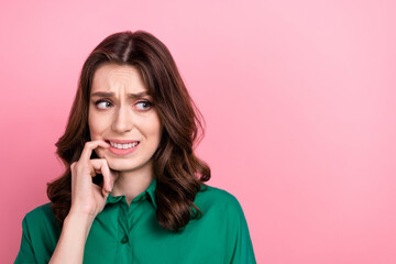 Sticker - Photo of uncertain nervous woman wear green shirt biting finger looking empty space isolated pink color background