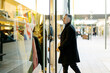 © Westend61 - Mature man entering clothing store