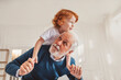 © Westend61 - Grandfather giving piggyback ride to grandson at home