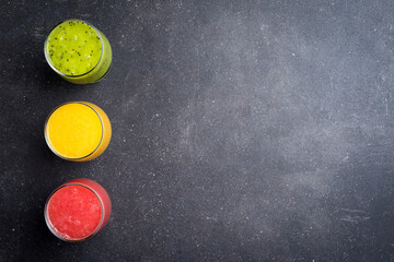 Poster - Glasses of fresh juice on gray stone table