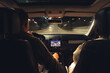 © puhimec - Man and woman in a car at night, view from the car.
