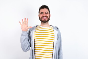 Sticker - Young caucasian mán wearing trendy clothes over white background showing and pointing up with fingers number five while smiling confident and happy.