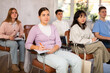 © JackF - High school students listening to lesson with interest and taking notes sitting on chairs in lecture room