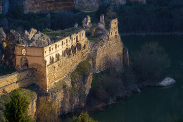 Ruins of old church by the river surrounded by limestone mountains