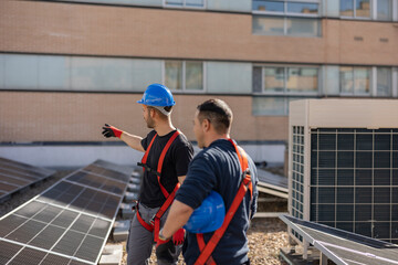 two solar panel technicians discussing installation