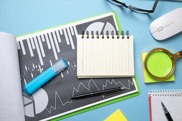 Wall Mural - Magnifying glass financial graphs and other business objects.