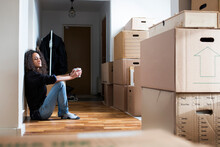 Woman Resting On Floor While Moving House