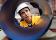 © Nassorn - Industrial Engineer wears safety helmet work in heavy metal engineering factory. Young female industry worker in hard hat checking production machinery equipment in metalwork manufacturing facility.