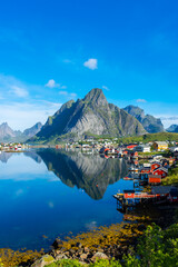 Perfect reflection of the Reine village on the water of the fjord in the Lofoten Islands,  Norway