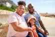 © Caia Image - Portrait happy gay male couple with daughter on summer beach
