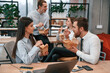 © standret - Group of coworkers are eating food from eco boxes in the office together