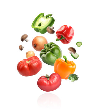Wall Mural - Many different fresh vegetables falling on white background