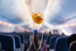 © tonefotografia - oxygen mask drop from the ceiling compartment on airplane..
